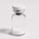 Clear glass vial with white cap containing white powder for peptide synthesis.
